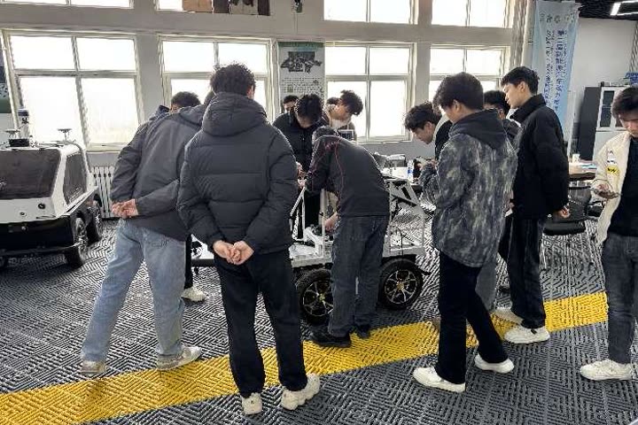 Students assembling an autonomous rover in a university lab